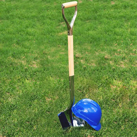 Polished Chrome Ceremonial Shovel For Groundbreakings And Ribbon Cuttings, 27 Inch D-Grip With American Ash Handle, next to hard hat