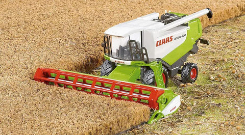 Claas Lexion 600 Farm Harvester Toy Built Tough In Metal And Plastic Green And Red 1:50 Scale in field with adjustable mower deck.