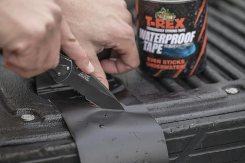 Heavy Duty Waterproof Repair Tape For Wet And Rough Surfaces Including Underwater Leaks Patching Up Like A Pro Indoors Or Outdoors 2 Inch By 5 Foot Black One Roll being applied and cut on a surface