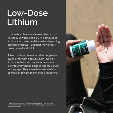 Person holding Lithium Orotate Brain Boost Support Supplement 60 capsules gluten free low dose 5 mg per serving bottle.