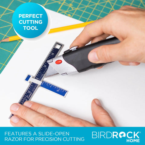 Retractable utility knife with black rubber handle cutting a blue ruler on white surface; BirdRock Home.