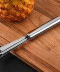 Pineapple Eye Remover And Core Cutter Tool V Shaped Stainless Steel Kitchen Gadget on a wooden board