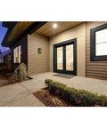 Endicott Collection 1 Light Outdoor Wall Lantern With Clear Seeded Glass on modern porch at dusk