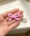 6 Pack Pink Bow Drawer Knobs Rock Solid Zinc Alloy Cabinet Hardware With Vintage Coquette Styling Super Cute Dresser Pulls with a pink bow shape on a hand.