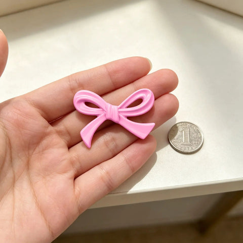 6 Pack Pink Bow Drawer Knobs Rock Solid Zinc Alloy Cabinet Hardware With Vintage Coquette Styling Super Cute Dresser Pulls with a pink bow shape on a hand.
