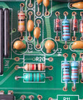Resistors on a green PCB; assorted carbon-film, 1/4W, 5% tolerance in various colors.