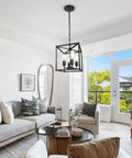 Four Light Black Farmhouse Chandelier With Iron Lantern Pendant Light Rustic Cage And Totally Adjustable Height Industrial E26 Base Hanging Fixture For Kitchen Island Dining Room Hallway Foyer Entryway installed in a modern living room.
