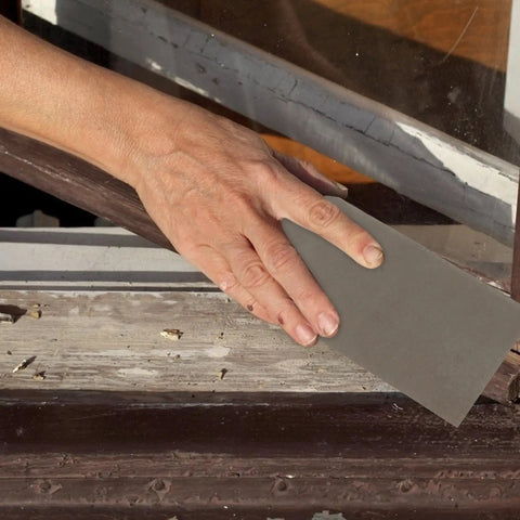 Person using Dope 45 Sheet Wet Dry Sandpaper Set Ranging 120 To 5000 Grit for sanding wood furniture.