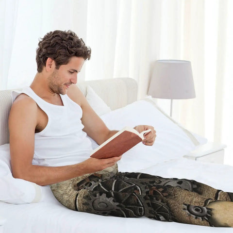 Stylish Steampunk Industrial Aged Human Heart Rusty Metal Gears Pajama Pants Lightweight Sleep Lounge Bottoms With Pockets And Button Fly For Men And Women Medium worn by a man reading in bed.