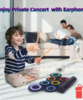 Child playing Roll Up Electronic Drum Pad Kit with 7 Pads, MIDI Output, headphones on, family in background on couch.
