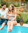 Twin Pack Outdoor Bluetooth Flame Speaker With LED Torch Dope Ambience Light by a poolside, IPX5 waterproof, garden use