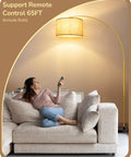 Woman relaxing on sofa beneath Gold Arched Floor Lamp With Remote And Dimmable Bulb Included Tall Mid Century Modern Reading Lamp For Living Room Office And Dining Area Adjustable Shade With 320 Degree Horizontal Rotation And 180 Degree Vertical Tilt.