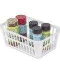 White Plastic Storage Baskets Set Of 48 For Grab And Go Organization filled with spice jars, on a kitchen countertop.
