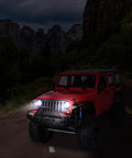RC crawler with 8 LED RC Light Kit featuring 4 white and 4 red lights, Traxxas Slash setup, on nighttime trail, receiver-powered.
