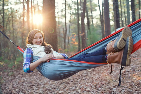 Person relaxing in a Lightweight One Person Portable Hammock For Camping Hiking Backpacking Travel Festivals And The Beach Seafoam Navy