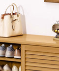 Spacious Six Tier Freestanding Shoe Cabinet Boasting Four Doors And A Nifty Drawer To Stow Away Your Best Kickers In Style placed beside a stylish handbag and decorative figurine.