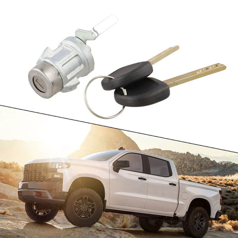 Chevy Colorado Manual Tailgate Lock Kit 23371760 with keys next to a white pickup truck in rocky terrain