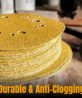 Workhorse 150 Grit Sanding Discs 50 Pack 6 Inch stacked with yellow abrasive, designed for quick smoothing on wood, drywall, and auto body.