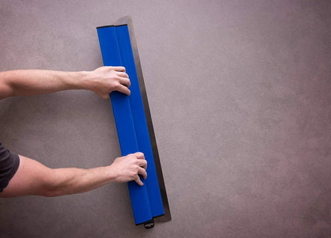 Hands using ProSkim Drywall Tool for ultra smooth finish with lightweight skimming blades, ergonomic non slip handle, 31.5 inch