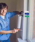 Okllen plastic flat shims for leveling; white shim held near window frame by installer in a blue shirt