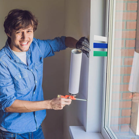 Okllen plastic flat shims for leveling; white shim held near window frame by installer in a blue shirt
