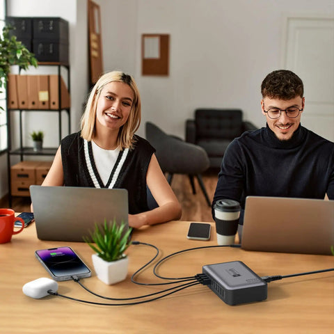 Office setup with laptops connected to GaN PD 450W 10 Ports USB C And USB A Charger Hub With 5 Type C And 5 USB A Ports on a desk.