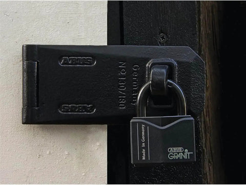 Granit Plus 14 Mm Hardened Steel Open Shackle Padlock on a door, showing rustproof alloy body and cataphoretic coating.