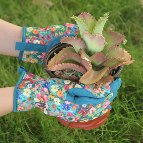 Woman wearing Womens Gardening Gloves With Printed Design And Touchscreen Grip For Thorn Proof Puncture Resistant Work Gloves For Weeding Planting Pruning And Daily Garden Tasks For Everyday Use holding a potted plant.