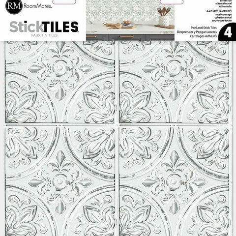 Box of White Tin Peel And Stick Tile Backsplash Kit With Self Adhesive Tiles, 4 Pack Of 10.5 Inch Squares, No Grout Needed, Easy DIY Kitchen Or Bath Makeover, 3.07 Sq Ft Coverage For A Quick Clean And Fresh Update, showing embossed floral pattern design.