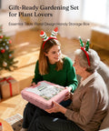 Two women with reindeer antlers holding 12-Piece Pink Yard Tool Set For Women And Men With Durable Carrying Case.