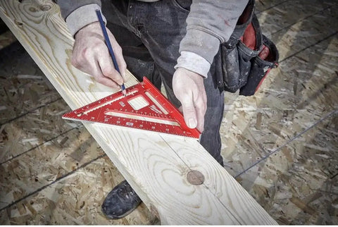 Carpenter using 7 Inch Magnetic Rafter Square With Rare Earth Magnets on wooden board for precise measurements.