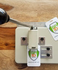 Heavy Duty Desktop Slot Punch For ID Cards And Bulk Badges With Precision Adjustable Slide Guides, showing ID cards in use.