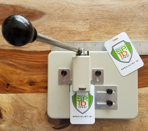 Heavy Duty Desktop Slot Punch For ID Cards And Bulk Badges With Precision Adjustable Slide Guides, showing ID cards in use.