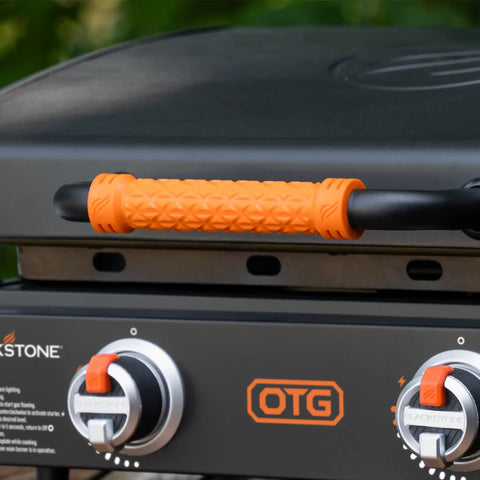 Close-up of 22-Inch Tabletop Griddle With Built-In Hood For Camping And Tailgating, orange handle and dual control knobs