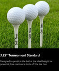Three golf balls on 3.25 inch tees on grass, featuring Premium Bamboo Golf Tees 83mm Set With Vintage Flip Top Case For Men.
