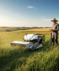 Man using Beast RC Tracked Lawn Mower With Wireless Remote Control Rugged Grass Cutter For Slopes And Uneven Ground in a field