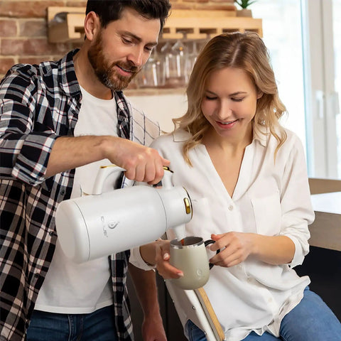 Man pouring coffee into mug using Thermal Stainless Steel Coffee Carafe With Double Wall Vacuum Insulation 68 Ounces Heat And Cold Retention Beverage Dispenser BPA Free SUS304 18 8 Steel White Gold Finish Office And Home Use Party Ready
