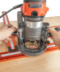 Adjustable Juice Groove Router Jig And Variable Square Template Guide With Precision Scaling For Cutting Boards Serving Trays And Pro Level Woodworking Projects With Zero Sweat Setup Measuring 23 6 By 23 6 In - close-up of router in use