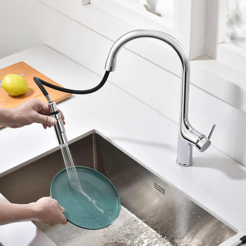 SUMERAIN Kitchen Faucet with Pull Down Sprayer Dual Mode Brushed Gold in action washing a teal plate over a sink.