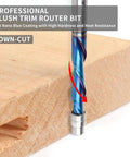 Kick Your Woodworking To The Next Level With This Flush Trim Router Bit That Delivers Crisp Clean Cuts While Slashing Chipping And Delivering Smooth Spirals For All Your Trimming Projects Across Various Materials Today. Close-up of down-cut flush trim router bit with nano blue coating on wood.