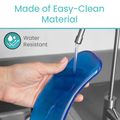 Hand holding water-resistant Gel Toilet Seat Cushion Pad With Raised Padded Riser For Elongated And Standard Toilet Seats And Commode Chairs 0.6 Inch Thick Gel Pad Delivers Pressure Relief And Pain Relief Comfy Seat Warmer And Adhesive Donut Pad For Seniors under faucet.