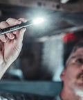 Man using Stylus Pro COB 160 Lumen USB Rechargeable Magnetic Penlight With Pocket Clip And USB Cord Blue in workshop