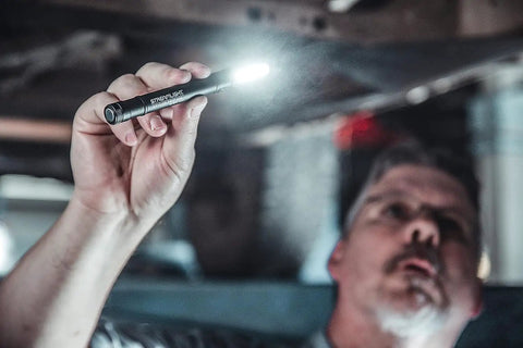 Man using Stylus Pro COB 160 Lumen USB Rechargeable Magnetic Penlight With Pocket Clip And USB Cord Blue in workshop