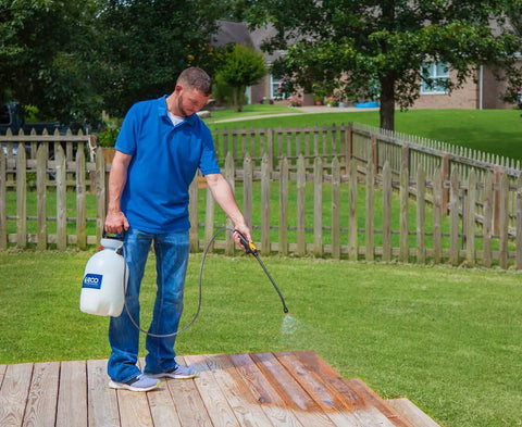 Man applying Exterior Wood Siloxane Waterproofing Sealer Easy Spray On Odorless Ready To Use Water Repellent for outdoor wood deck.