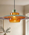 Amber Glass Pendant Light Modern: 19-inch Metal Chandeliers For Dining Room with layered amber glass and green accents.