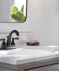 Elmhurst Two-Handle Centerset Bath Faucet in Oil Rubbed Bronze on white sink
