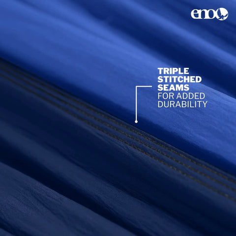 Close-up of blue fabric with text highlighting triple stitched seams for durability on DoubleNest Lightweight Camping Hammock For 1 To 2 People With 400 Lb Capacity, 9.5 Ft Long, Ultralight 19 Oz, Easy Setup, Strap Friendly, Royal Navy Color For Trails, Campgrounds, And Backyard Chill.