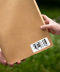 Heavy Duty Thermal Transfer Shipping Labels 2 X 1 Inches on a package with a clear barcode for easy scanning.