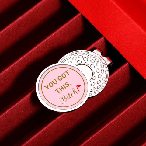 Cute Pink Golf Ball Marker Hat Clip For Women Gals Golf Accessory on textured surface with inspirational message
