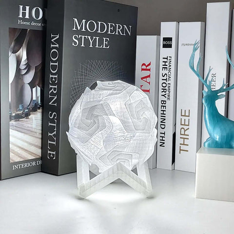Crystal Clear PETG Filament 1.75mm 1kg For 3D Printing, glasslike lampshade on a shelf with books and decor